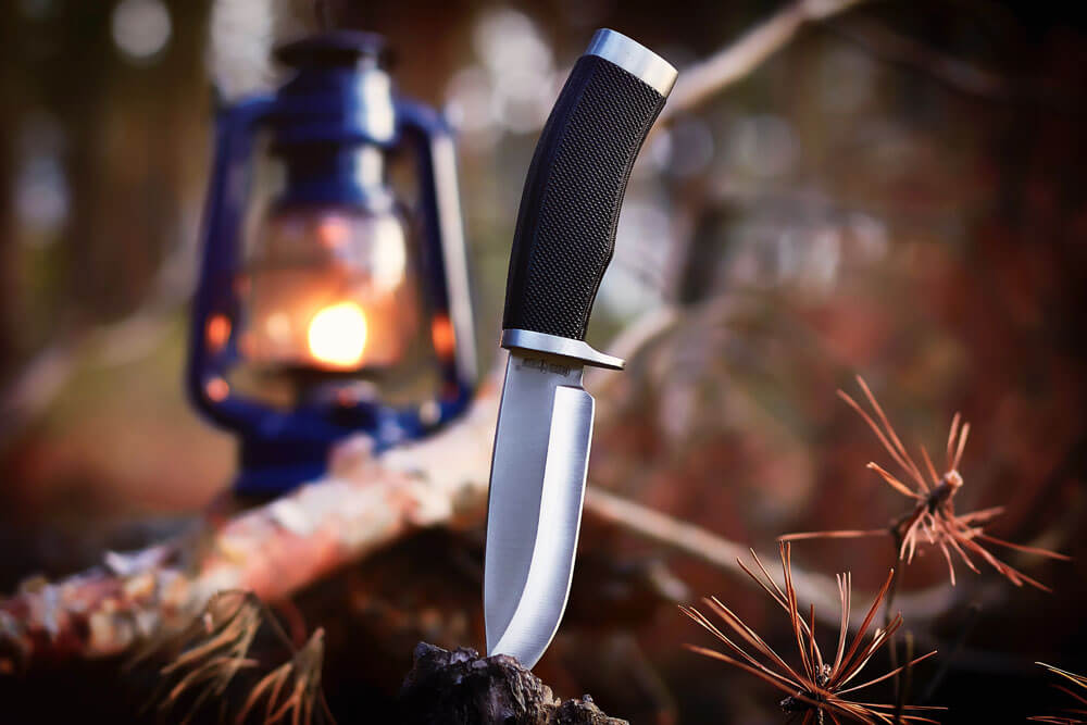 A survival knife put into the wood